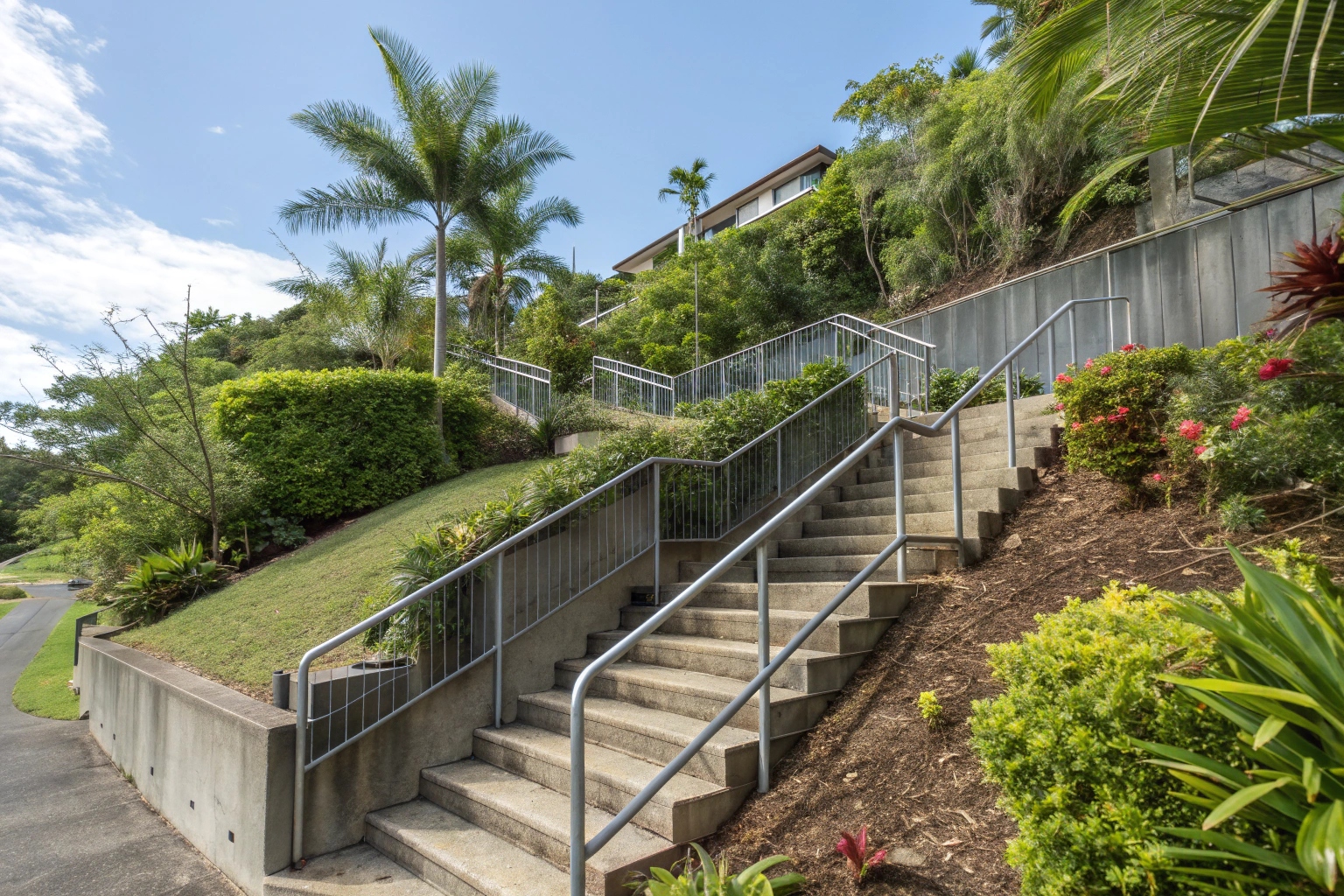 Multi-level concrete steps for steep Logan property with safety handrails